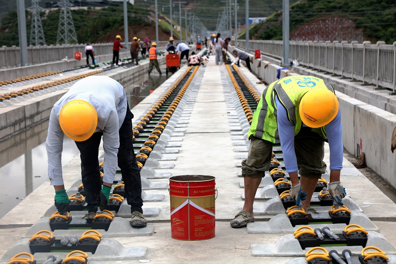 图5：高铁建设者正在安放轨道螺丝钉。